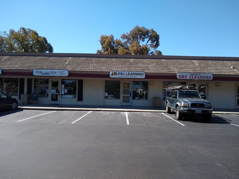 The single-story shopping center row with parking out front; the Vonnie's Dry Cleaners sign is on the right.